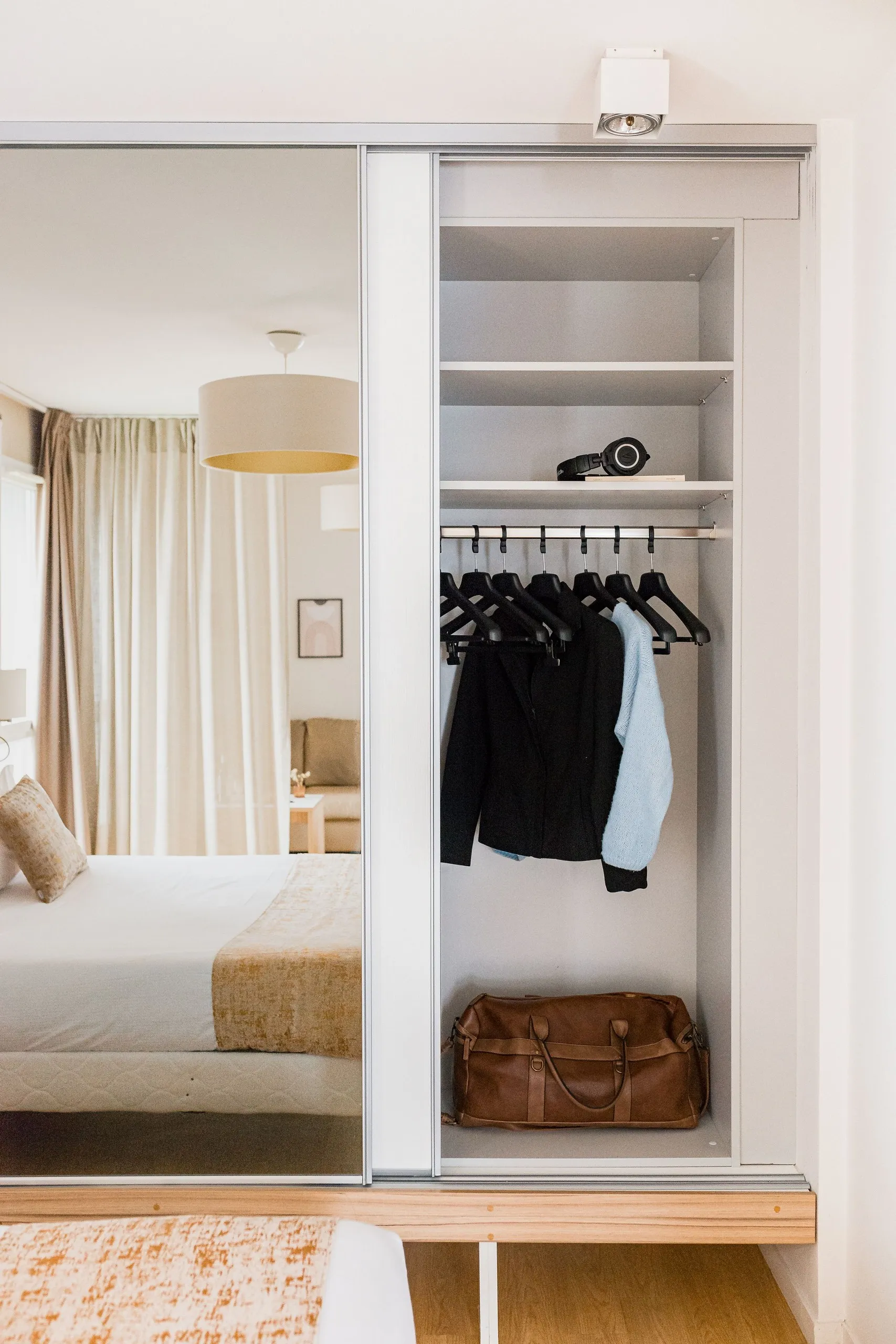 Chambre avec lit, armoire, vêtements suspendus 